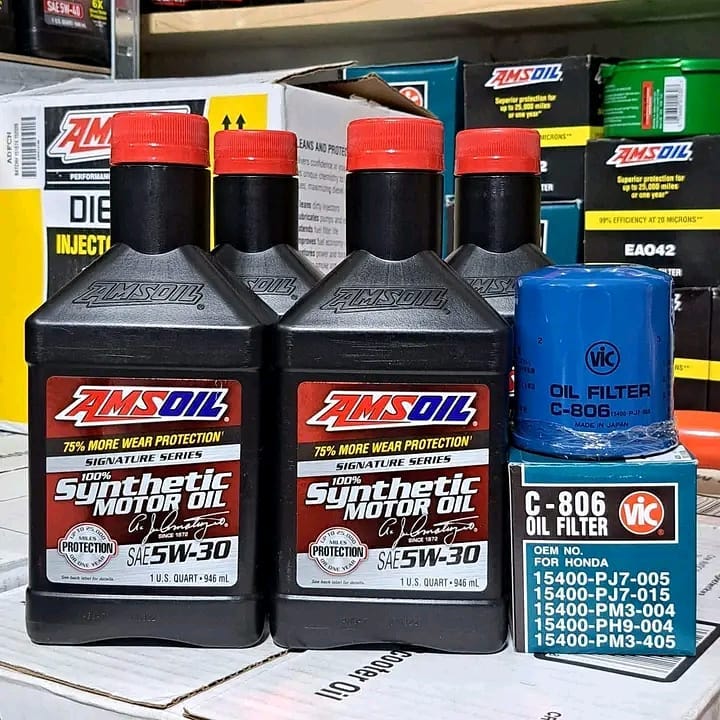 Complete AMSOIL oil change kit with instructions for easy use. "High-quality AMSOIL synthetic oil designed for superior engine protection.