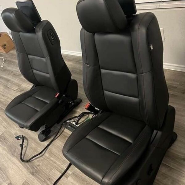 Black leather seats with red stitching in Dodge Durango Close-up of red stitching on Dodge Durango leather seats